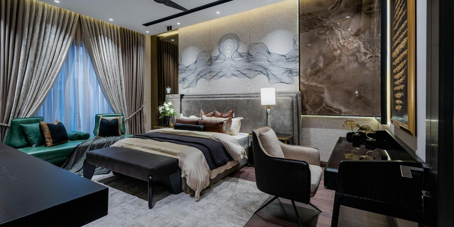 Luxury bedroom with bespoke feature wall, upholstered bed, decorative lighting and premium interior finishes