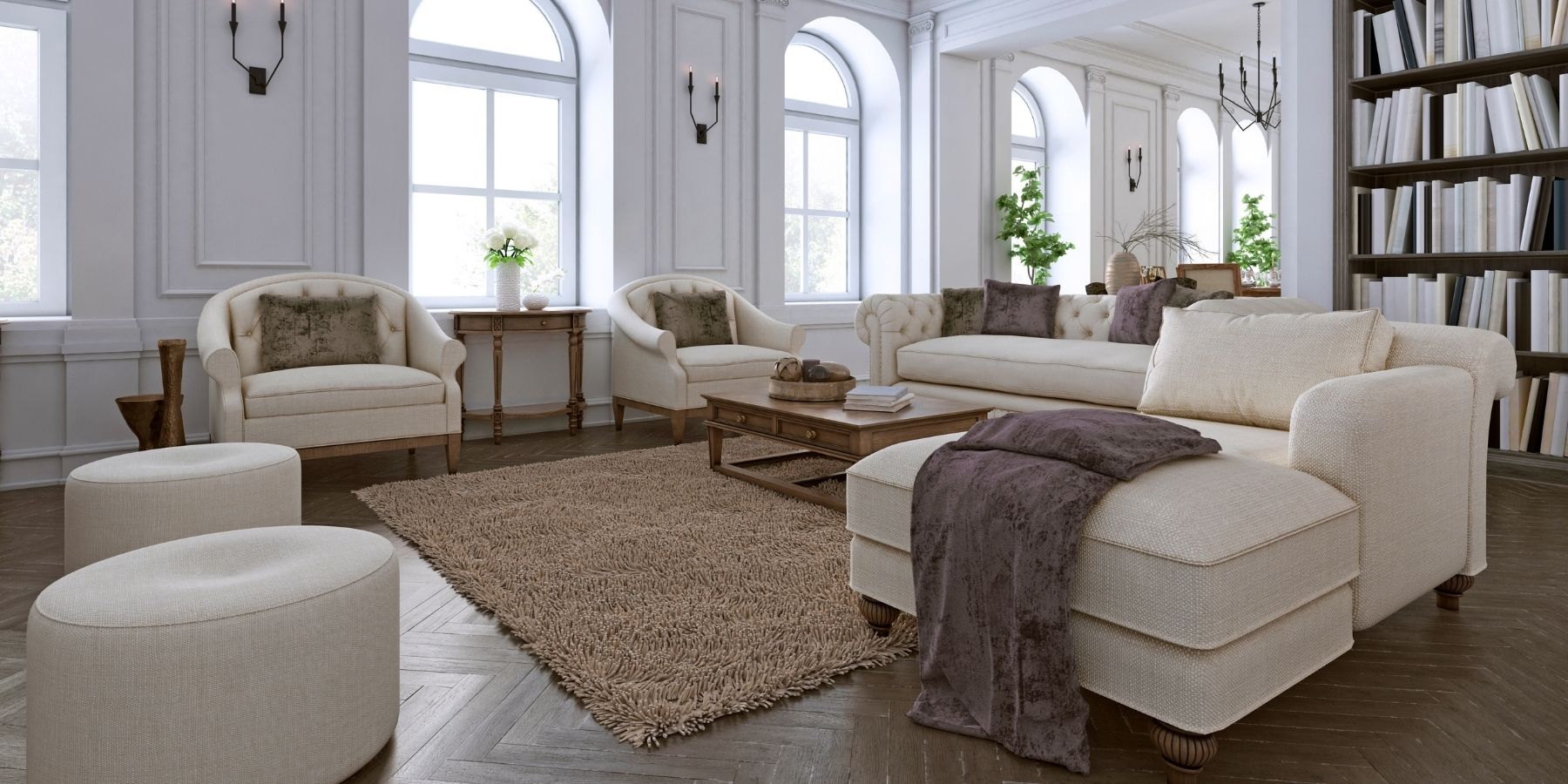 Elegant living room with arched windows, decorative wall panelling, timber flooring and built-in shelving