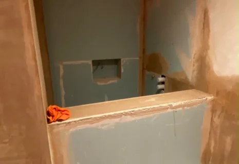 Bathroom renovation in progress with new wall boards, plaster preparation and fitted bath in Notting Hill