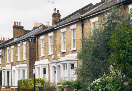 Traditional brick terraced houses with bay windows and established front gardens in Ealing