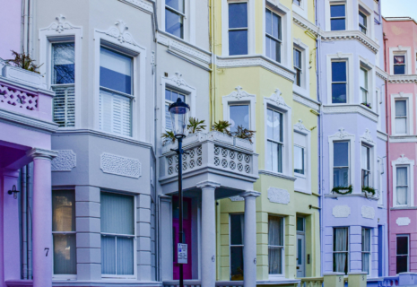 Colourful period townhouses with bay windows and decorative facades