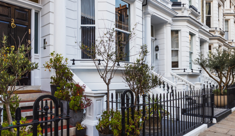 White period townhouses with black iron railings and front gardens in Fulham, London