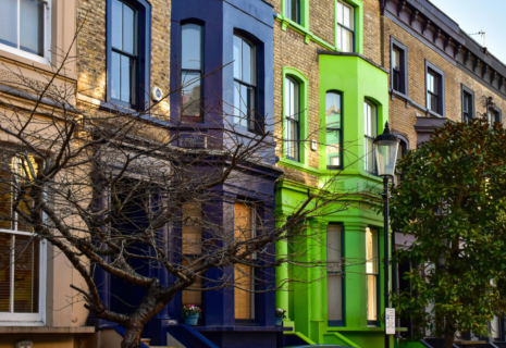 Colourful period townhouses with bay windows and decorative facades in Kensington, London