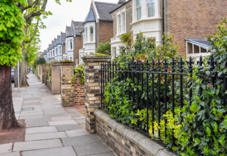 Tree-lined residential street with period houses and front gardens in Richmond, London
