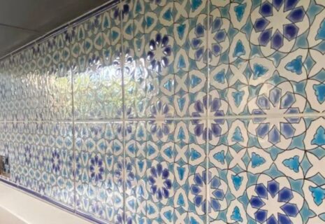 Decorative blue and white patterned wall tiles installed in a kitchen