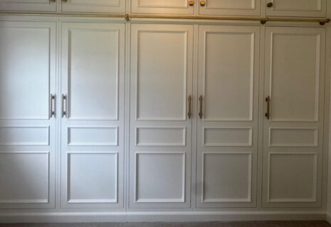 Bespoke fitted wardrobes with panelled doors and built-in storage