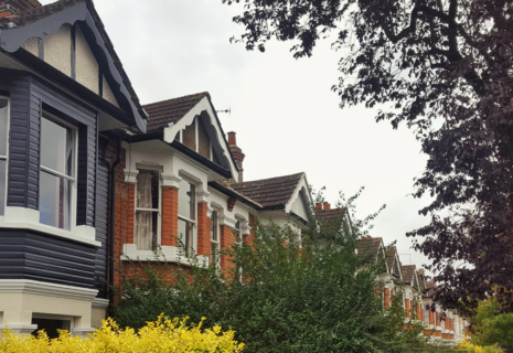 Row of period residential houses with bay windows and mature trees in West Ealing, London